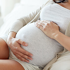 pregnant woman with hands on stomach