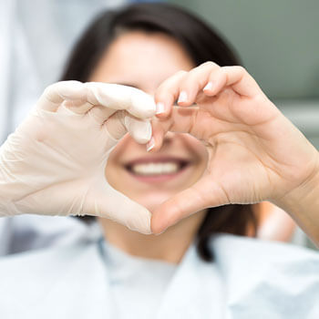 dentist making a heart with her hands