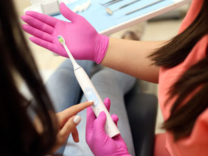 Dentist holding electric toothbrush