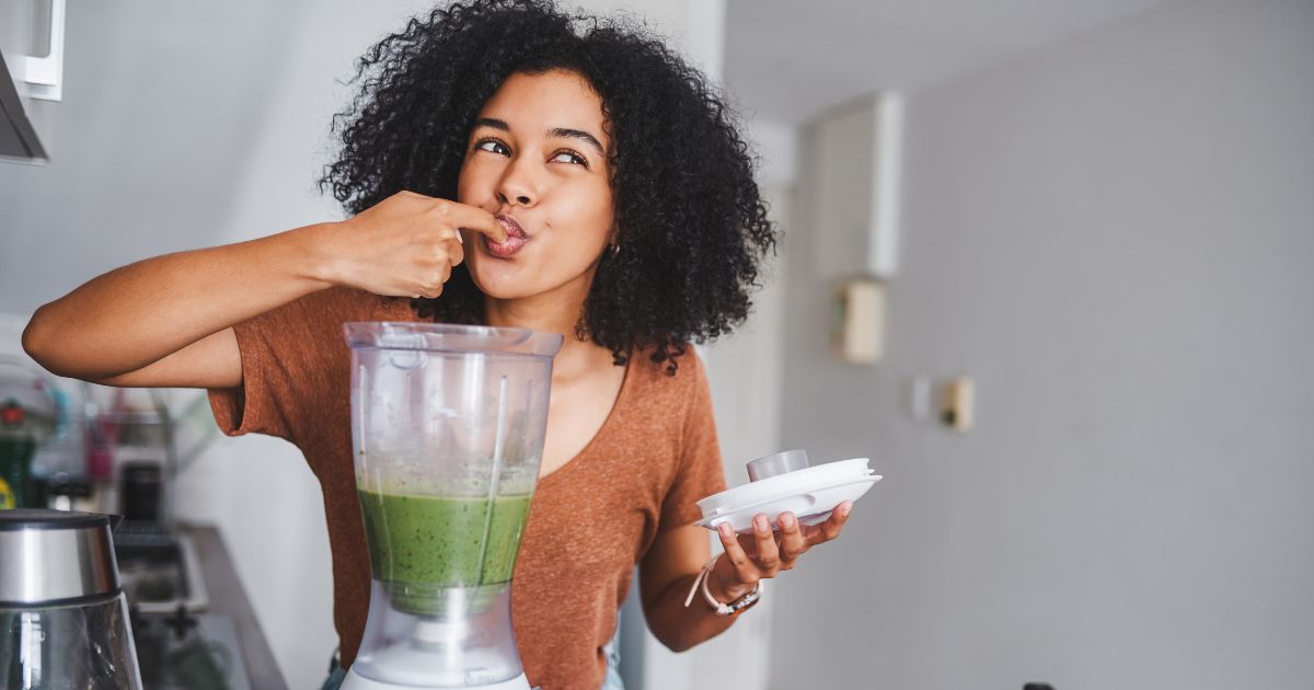 Woman making green smoothie