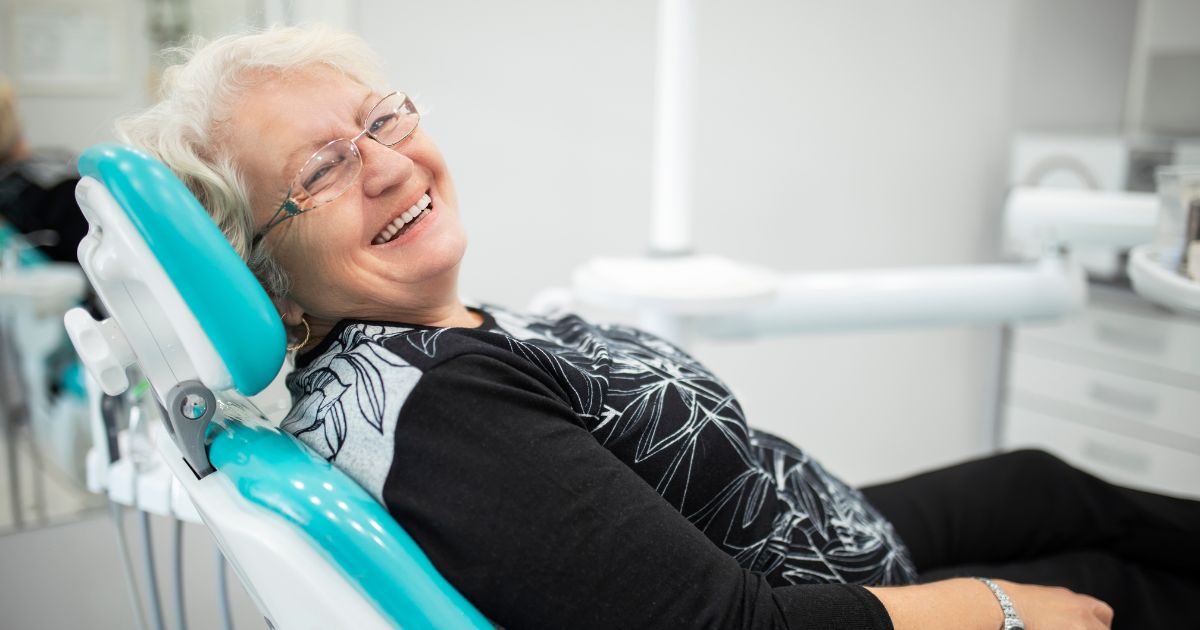 Woman smiling in dental chair.