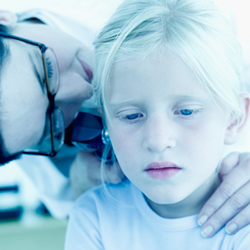 doctor checking child's ear