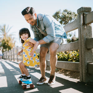 Father and daughter skateboarding