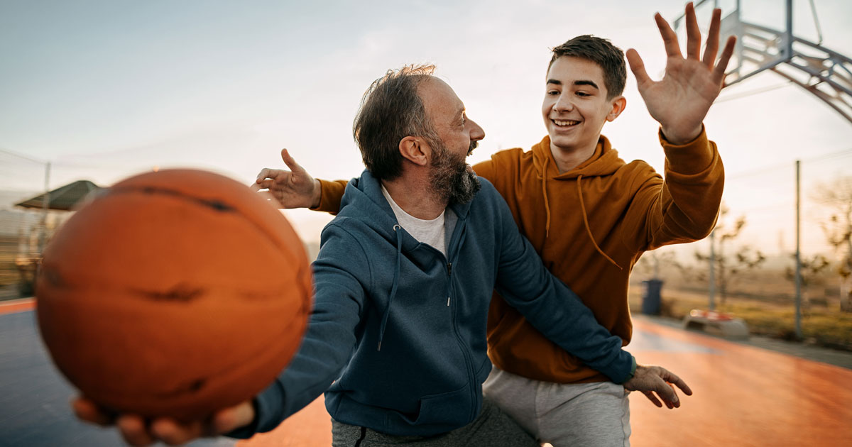Father and son playing basketball