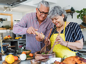 man and woman cooking together in a kitchen