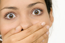 Fearful woman covering her mouth
