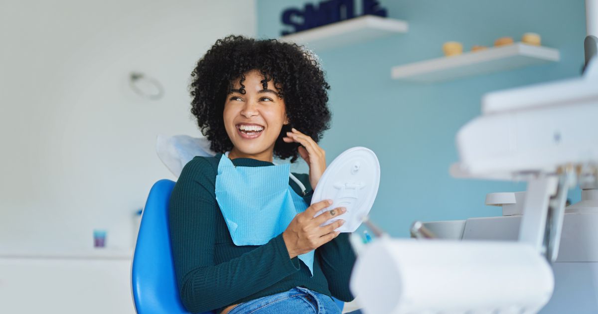 Woman smiling in dental chair.