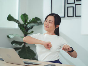 woman stretching at desk