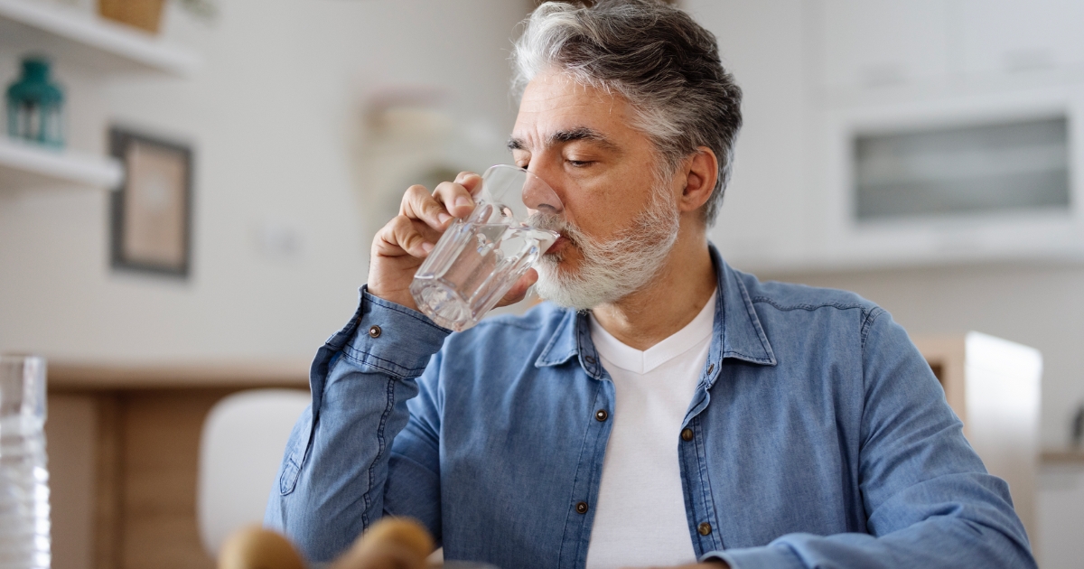 Man drinking glass of water.