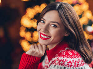 Woman in holiday sweater with beautiful smile