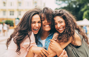 women hugging and smiling