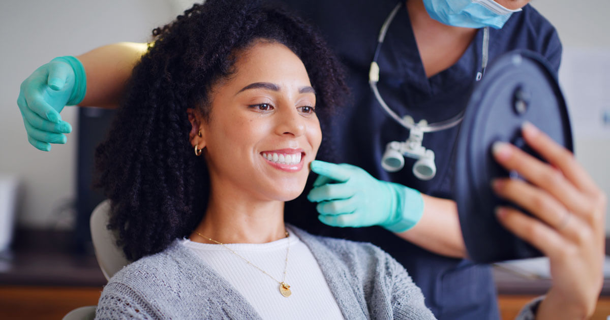 woman observing dental bite in mirror
