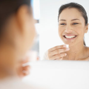 Woman smiling in mirror.
