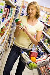 woman reading labels in grocery store