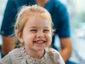smiling kid in dentists chair