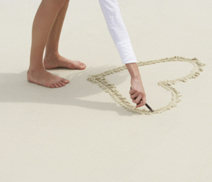 Drawing a heart in the sand