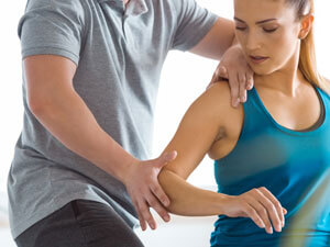 woman having arm adjusted