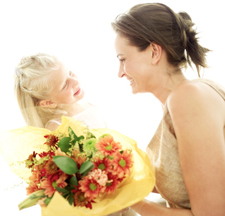 Daughter handing mother flowers