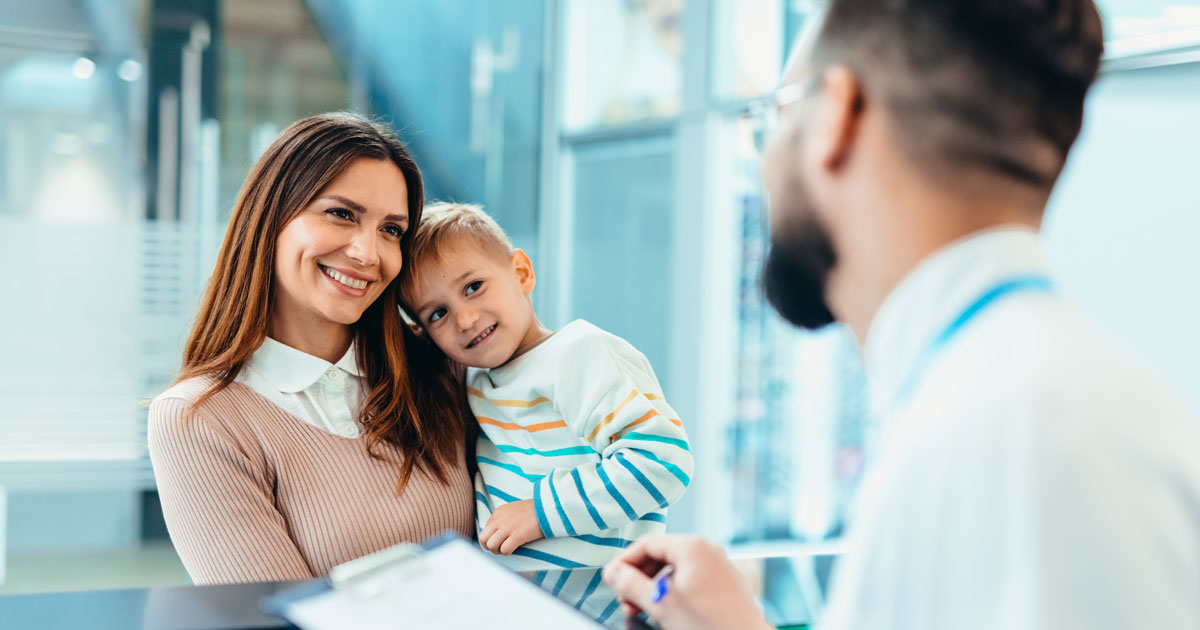 Mother and son smiling at dentist