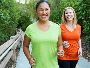 2 women walking outdoors together