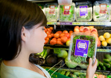 Woman reading a food label in supermarket