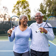 older couple playing tennis