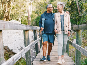 older couple walking on a bridge