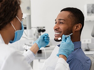 smiling man sitting in dentists chair