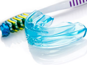 Mouthguard with toothbrush