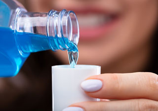 Woman pouring mouthwash