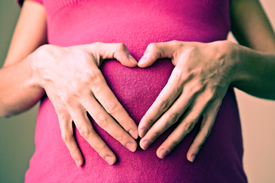 Ladies hand on pregnant belly