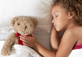 Girl sleeping with her teddy bear