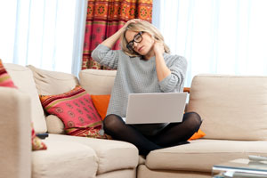 woman with neck pain at desk