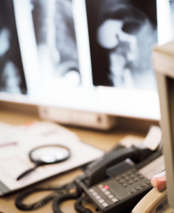 office desk with x-rays in background