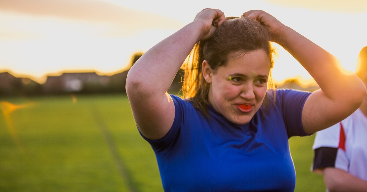 Female athlete wearing mouthguard.