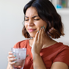 woman with tooth pain after drinking ice water