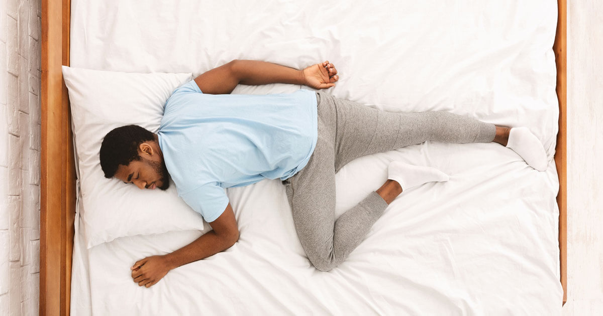 man sleeping on stomach