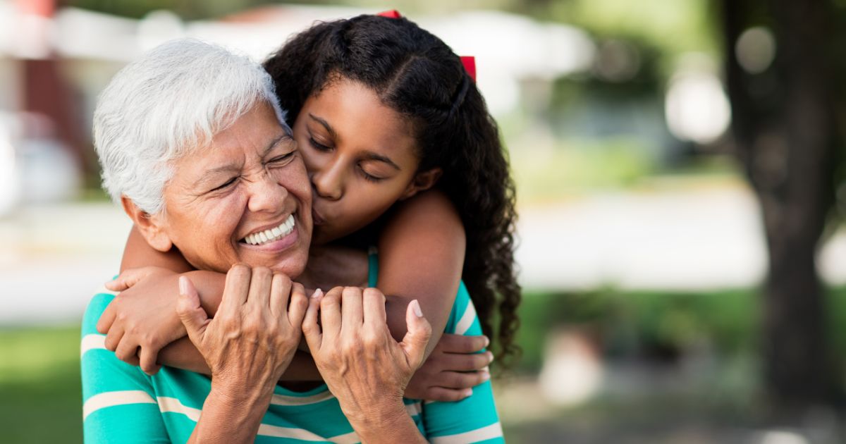 Girl hugging her grandma.