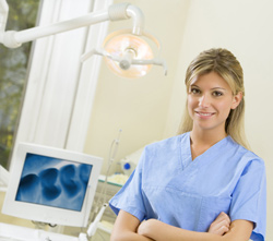 Dental assistant next to chair side computer