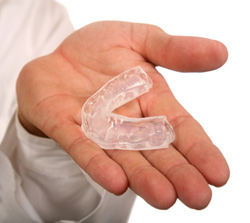 Dentist holding a custom mouth guard