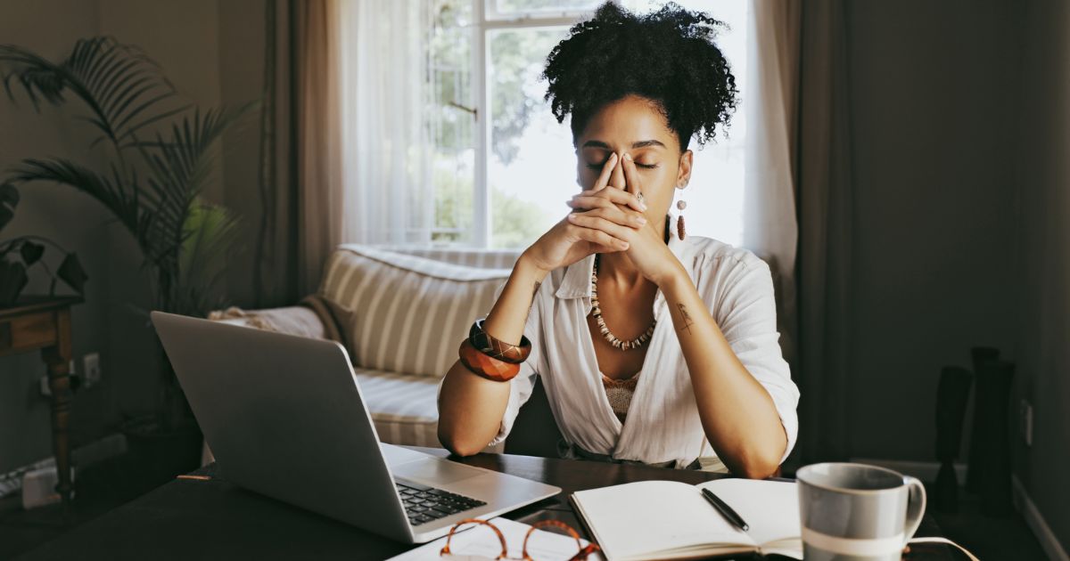Stressed woman at desk.
