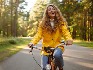 smiling woman riding bike