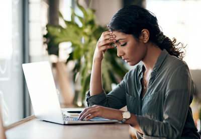 stressed woman looking at computer