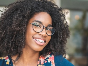 teenager with braces smiling