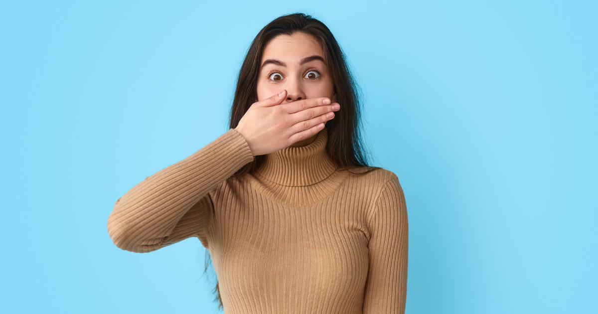 Woman covering her smile.