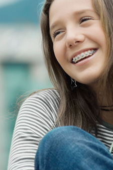 Close-up of a teenage girl smiling with braces