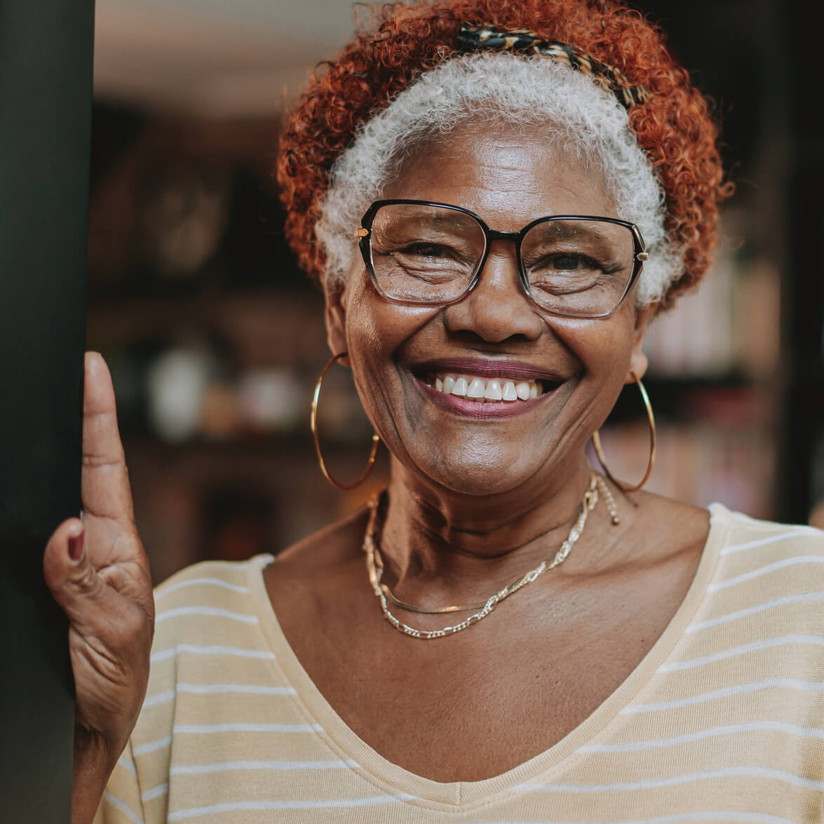 smiling woman leaning against doorway