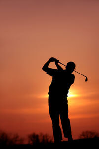 golfing at sunset