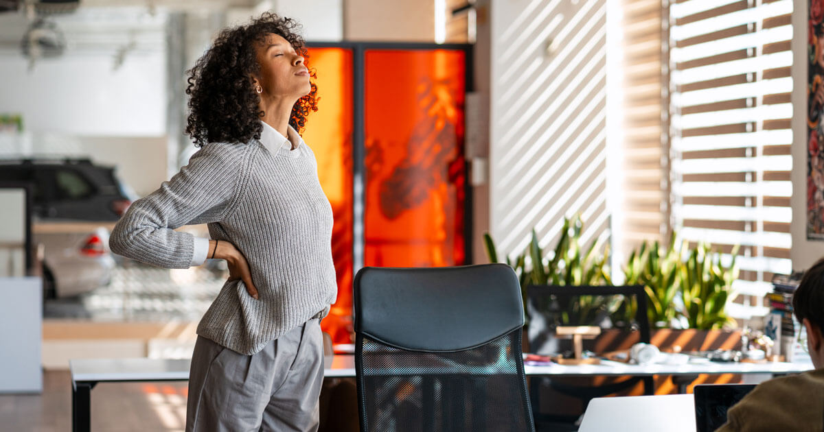 woman standing to crack her own back