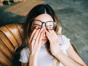 woman with glasses having headache pain